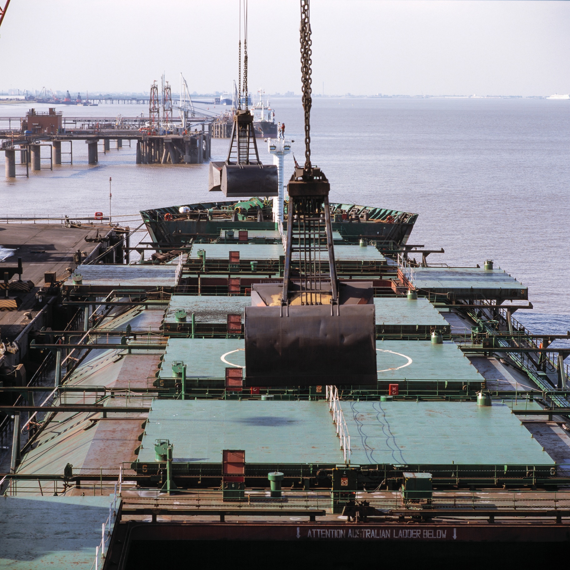 Industrial cargo ship loading at dockyard port
